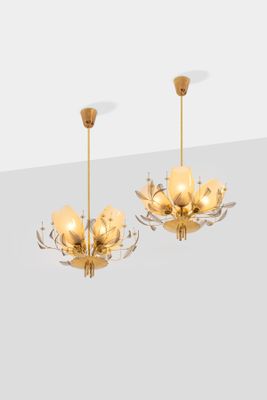 a pair of chandeliers in the style of chandeliers