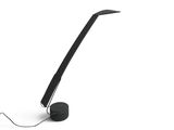 a black lamp that is sitting on a white surface