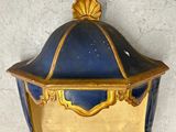a blue and gold lantern hanging on the wall