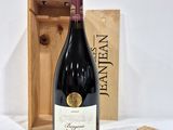 a bottle of wine that is sitting next to a wooden box