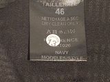 the back of a black shirt with a tag on it