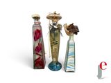 three glass vases with flowers in them sitting next to each other