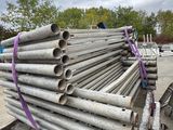 a pile of pipes sitting on top of a pile of wood