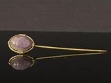 an image of a gold and purple broochle broochle pin