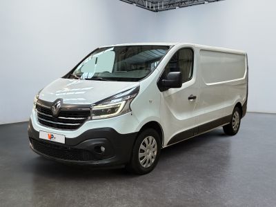 the white van is parked in a large room with a black floor