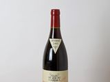 a bottle of wine sitting on a wooden table