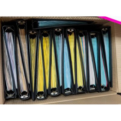 many files in a box with a pink ribbon