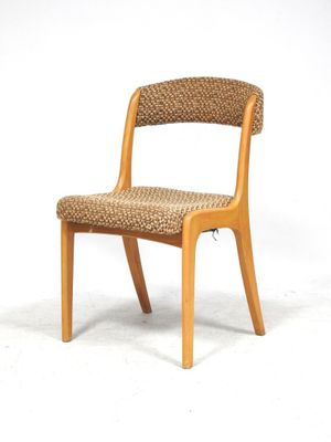 a wooden chair with a woven seat on a white background