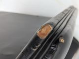 a piece of black leather with a hole in the middle of it
