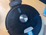 a robot that is sitting on a table next to a laptop