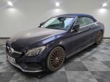 a blue mercedes s - class cab is parked in a showroom
