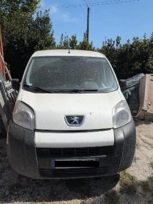 a white van that is parked in the dirt
