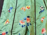 an image of a close up of a green skirt with flowers on it
