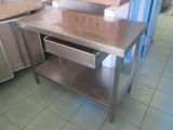 a stainless steel table with a drawer underneath it