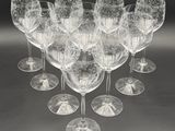 many wine glasses that are lined up together on the table