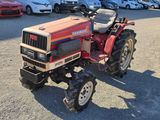 a red tractor that is parked in a parking lot
