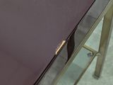 a table with a glass top and a metal base