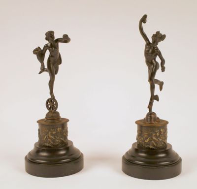 a pair of bronze figurines of a boy and a girl