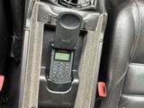 a cell phone in the center console of a car