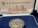 a silver coin with a picture of a man on it