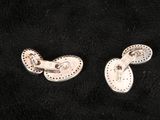 pair of silver plated earrings on a black background