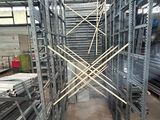 many shelves in the warehouse with metal bars on them