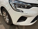 the front end of a white car with a damaged bumper