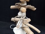 a wooden sculpture of a man holding a bunch of sticks