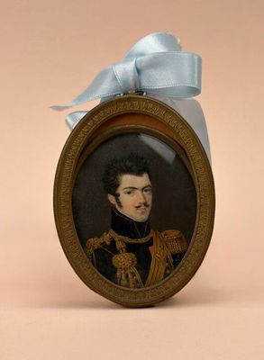 a miniature picture of a man in uniform with a blue bow