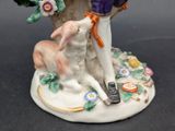 a figurine of a man and a dog on a table