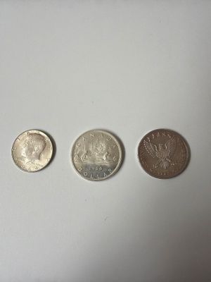 three different types of coins sitting on a white surface