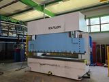 an image of a large machine in a warehouse with lots of windows