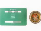 a green card and a compass on a white surface