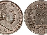 a silver coin with a crown on top of it