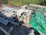 a pile of concrete blocks on the ground next to a fence