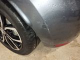 a close up of a tire on a car in a garage