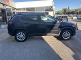 a black jeep compass parked in front of a building