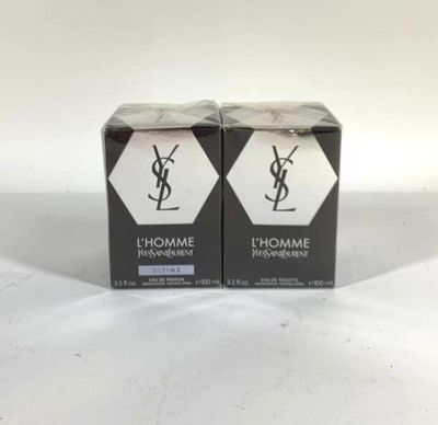 two boxes of yslhomme perfume sitting on a white surface