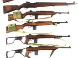 a group of six rifles with different types of wood and metal