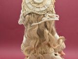 a doll of a woman with long hair wearing a hat