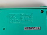 a close up of a green nintendo wii game console
