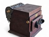 an old camera that is sitting on a white surface