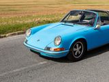 a blue car that is driving down the road