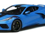 the blue sports car is parked on a white surface
