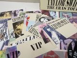 a pile of posters on a table with a pair of shoes