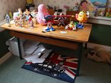 a wooden table with a bunch of toys on top of it