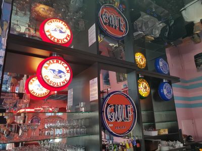 a bar with a lot of different signs on the wall