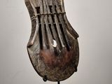 sculpture of a musical instrument on a stand on a white surface