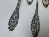 three spoons that are sitting on a table