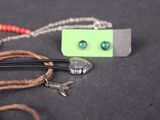 a necklace and a pair of scissors on a table